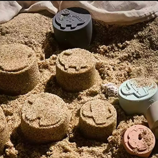 Silicone stacking cups used as beach sand moulds. Features animal-shaped imprints, perfect for creative play, beach fun, and building sensory skills outdoors.