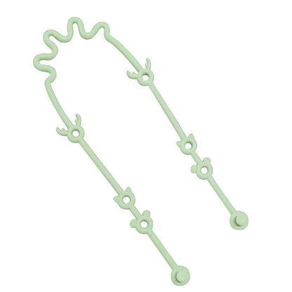 Mint green silicone toy strap with loop and link design, shown in a flexible curved position.
