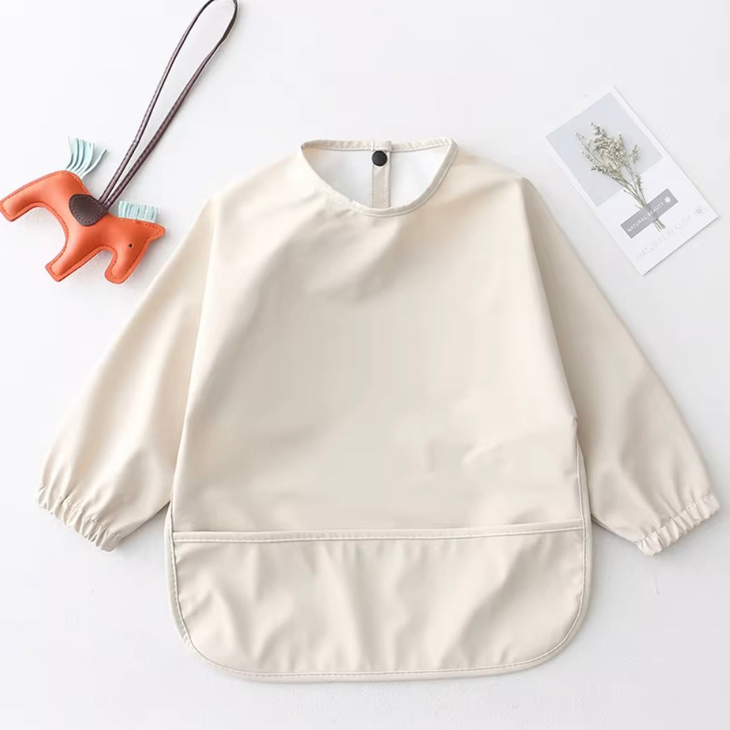 Mess Mate cream-coloured sleeved smock bib with full coverage design.