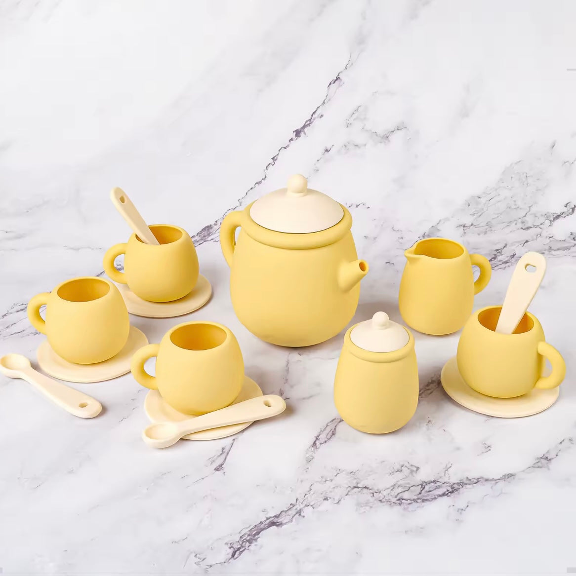 Tiny Sips silicone tea set in soft yellow, featuring cups, teapot, and saucers. Durable, food-grade, and easy to clean perfect for toddler playtime.