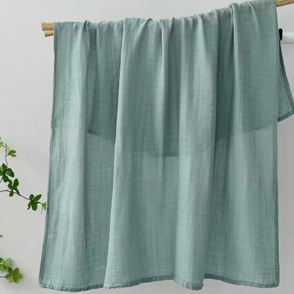Sage green muslin baby wrap, breathable, versatile, and gentle on baby’s skin.