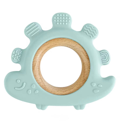 Mint green dinosaur teether, soft silicone with natural wood ring.