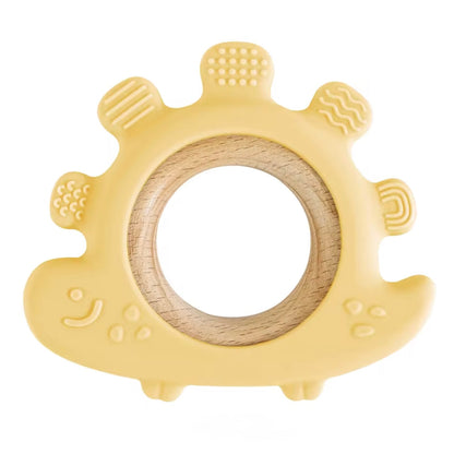 Yellow dinosaur baby teether with textured silicone edges and wooden ring.