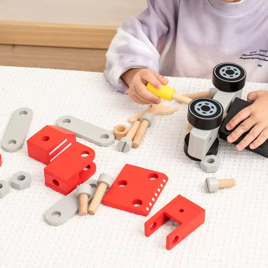 “Toddler assembling wooden construction vehicle parts, encouraging creativity, fine motor skills, and hands-on play.”
