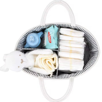 White nappy caddy filled with baby essentials including nappies, wipes, bottle, and soft toy for easy organisation.