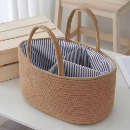 Tan cotton rope nappy caddy with striped lining and handles, perfect for keeping baby essentials tidy.