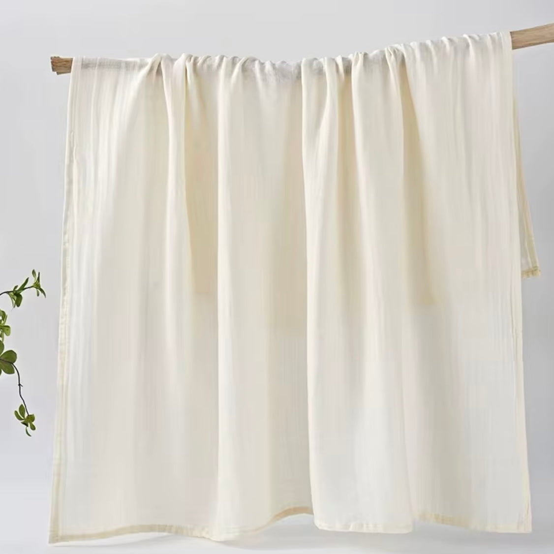  Classic white muslin baby wrap, soft and versatile for swaddling and comfort.