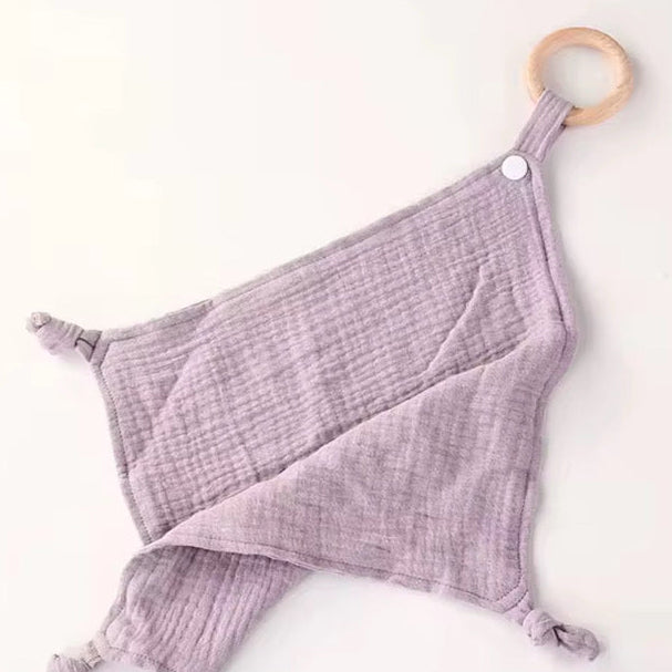 Lilac purple muslin comforter with wooden teether ring, designed for baby comfort, soothing, and snuggling.