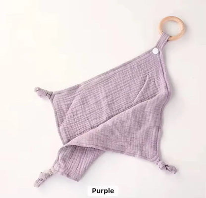Lilac purple muslin comforter with wooden teether ring, designed for baby comfort, soothing, and snuggling.
