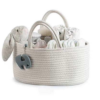 Light grey nappy caddy with compartments, neatly holding baby bottles, nappies, and essentials, nursery-ready.