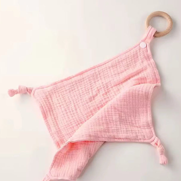 Pink muslin comforter with wooden teether ring, perfect for soothing, snuggling, and teething relief.
