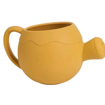 Yellow silicone watering can for children, lightweight and durable for outdoor play.