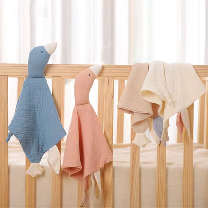 Blue, Pink & Cream on Cot
“Little Honkers muslin goose comforters in blue, pink, and cream hanging on a wooden baby cot.”