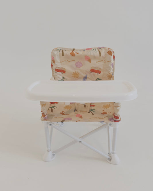 Small folding chair with a patterned seat and backrest on a white background