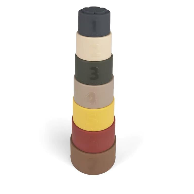 Seven earthy-tone silicone stacking cups stacked into a tower. Designed to encourage problem-solving, counting, and fine motor skill development for toddlers.