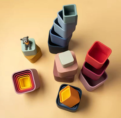 Mixed colour stacks
“Set of colourful silicone nesting and stacking cups in square shape, arranged in towers and groups.