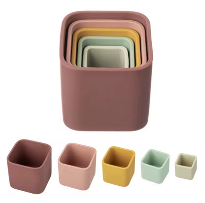 Warm tone set
“Set of 5 silicone stacking cups in earthy colours including pink, mustard, and green nested together.