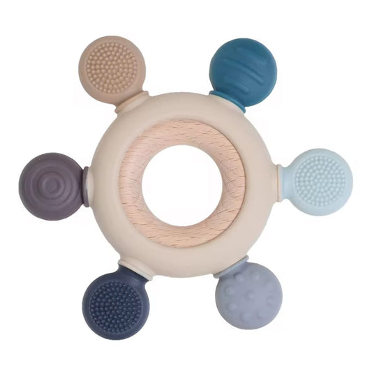 Round wooden teether with six silicone sensory ends in blue, grey, and neutral shades, each with textured patterns for chewing.