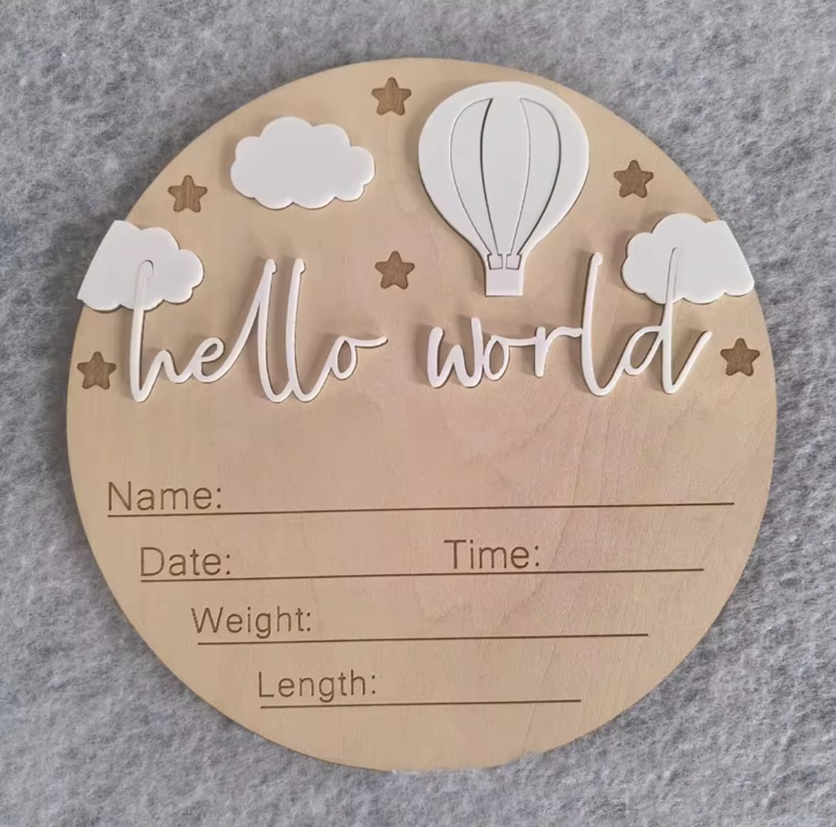 White hot air balloon hello world plaque – Baby milestone wooden disc with deep red balloon, stars, white clouds, and engraved name/date details.