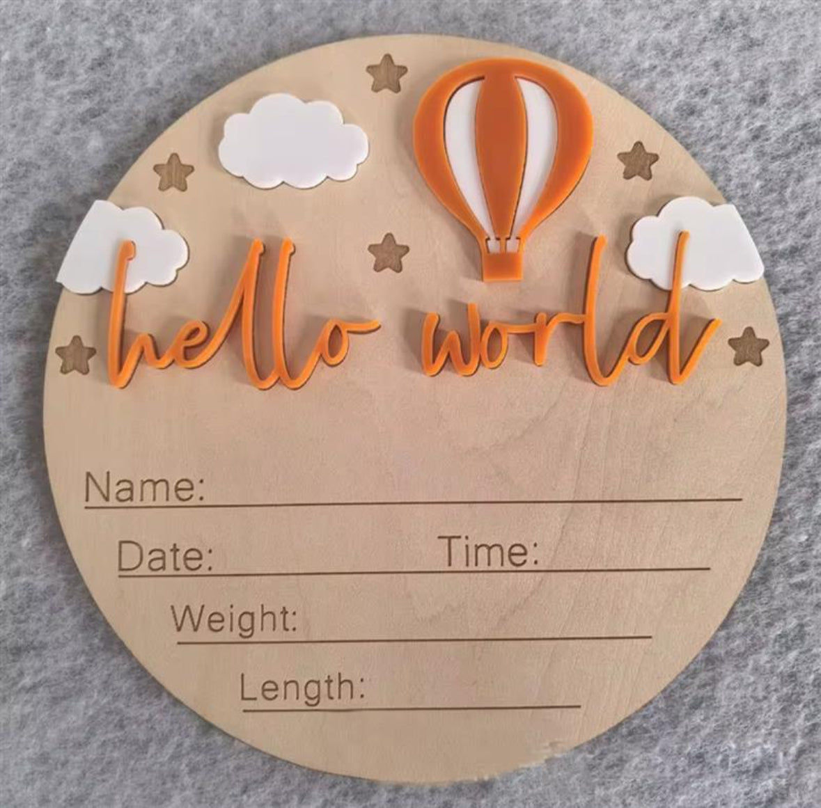 Orange hot air balloon hello world plaque – Wooden birth announcement plaque with bright orange balloon, white clouds, stars, and engraved details.
